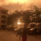 People run after a natural gas station explodes in Accra.